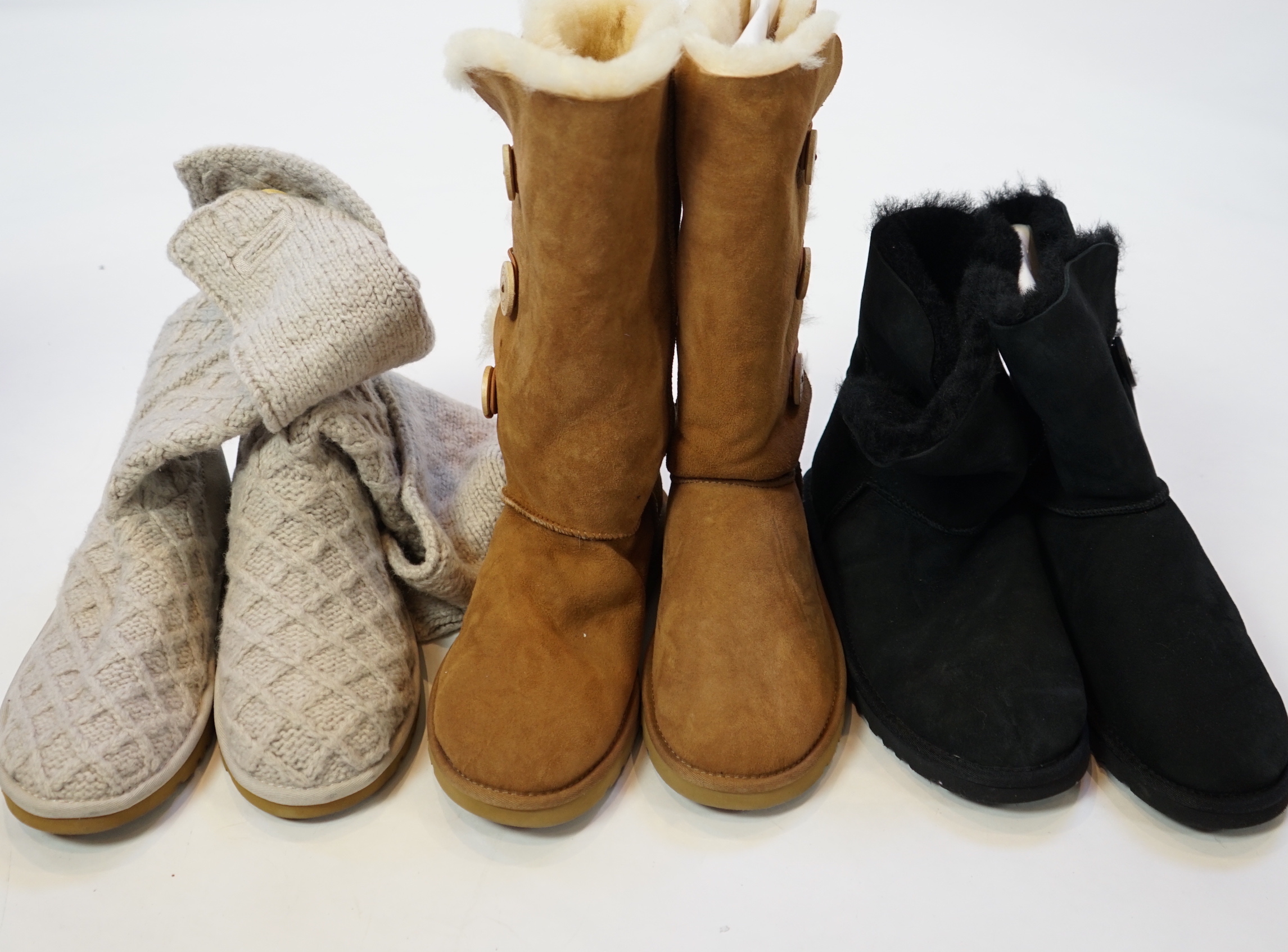 Three pairs of lady's low/mid height UGG sheepskin boots with side button design, size UK 7.5